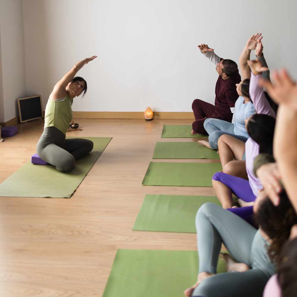 adults-practicing-side-bend-pose-during-yoga-class-EP5DGFF.jpg